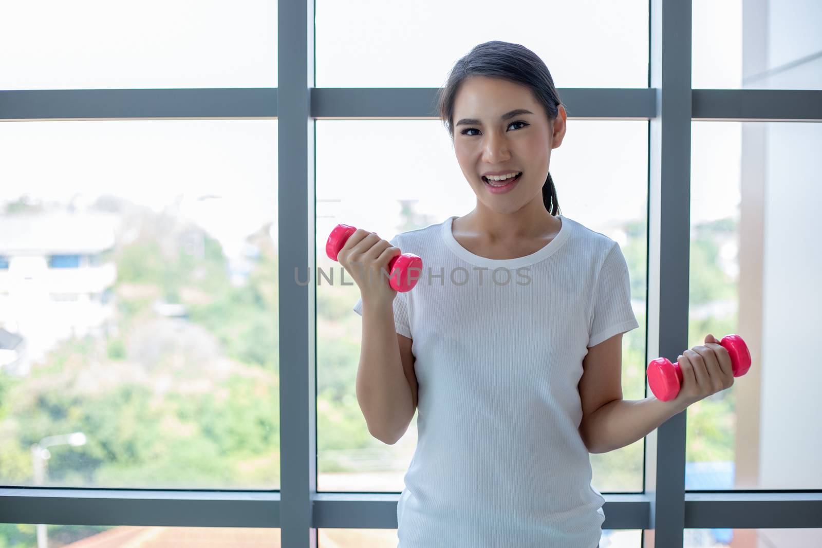 beautiful muscular fit woman exercising building muscles and fitness woman doing exercises in the gym. Fitness - concept of healthy lifestyle