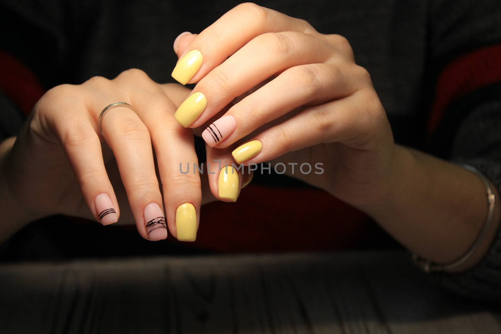 Christmas Nail art manicure. Winter Holiday style bright Manicure with gems Christmas tree and snowflakes. Bottle of Nail Polish.