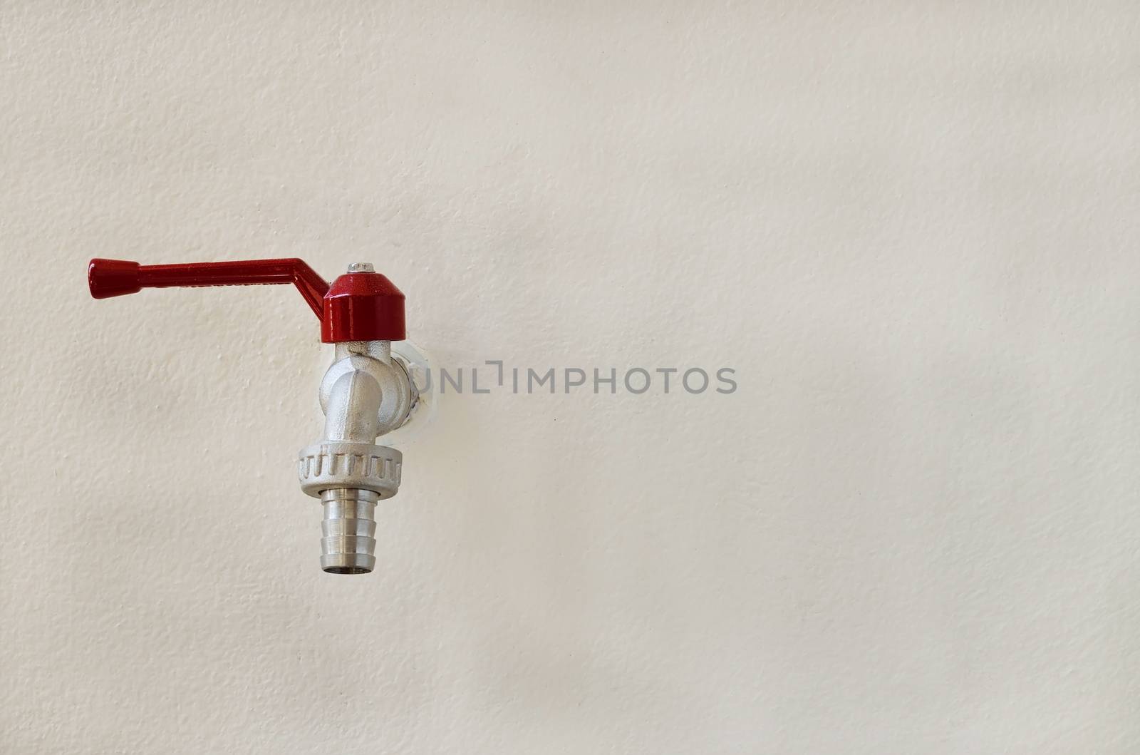 faucet valve on concrete old wall background