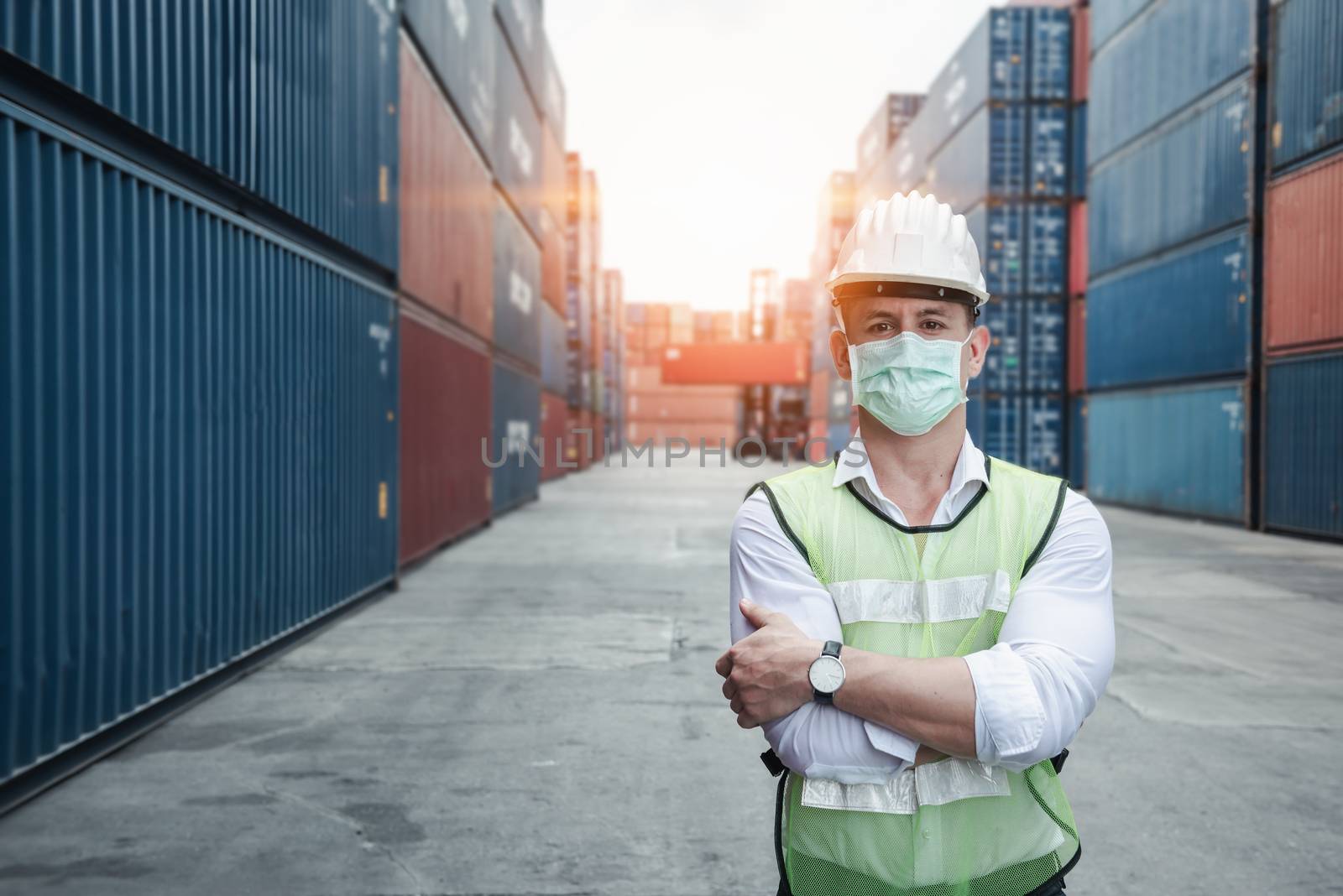 Transport Engineer Man Wearing Medical Face Mask for Prevention Coronavirus Epidemic Situation in Containers Logistic Shipping Yard. Transportation and Logistics after Coronavirus Covid-19 New Normal