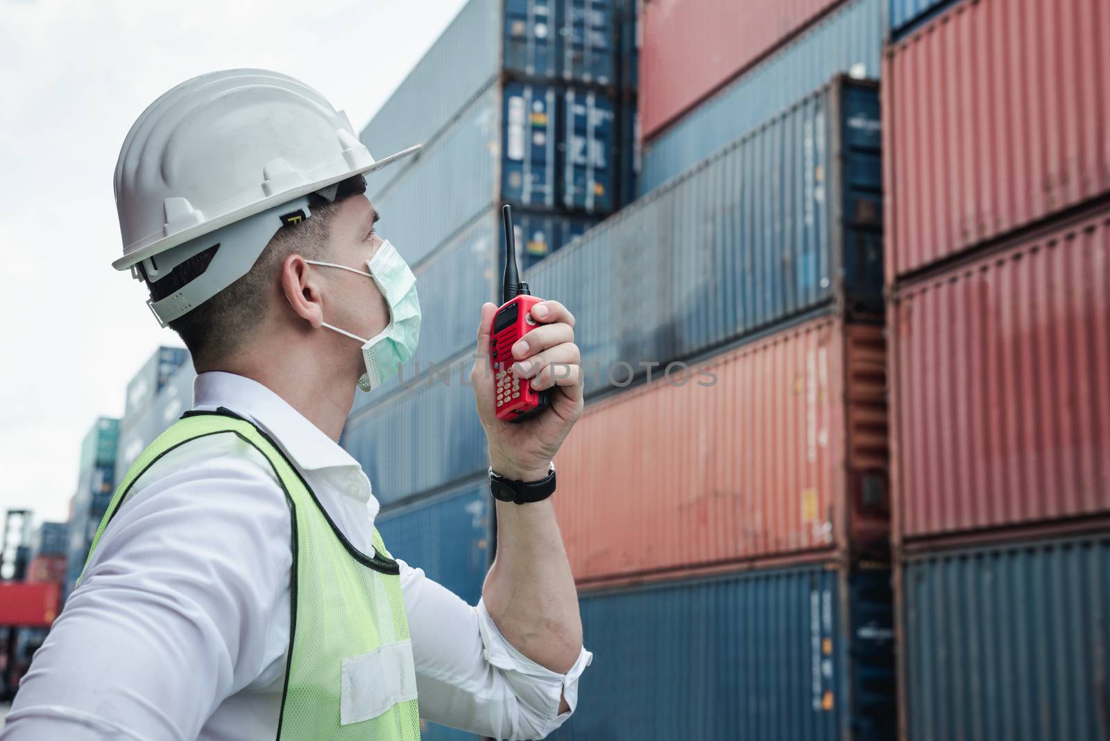 Container Logistics Shipping Management of Transportation Industry, Transport Engineer Control Via Walkie-Talkie to Worker in Containers Shipyard. Business Cargo Ship Import/Export Factory Logistic. by MahaHeang245789