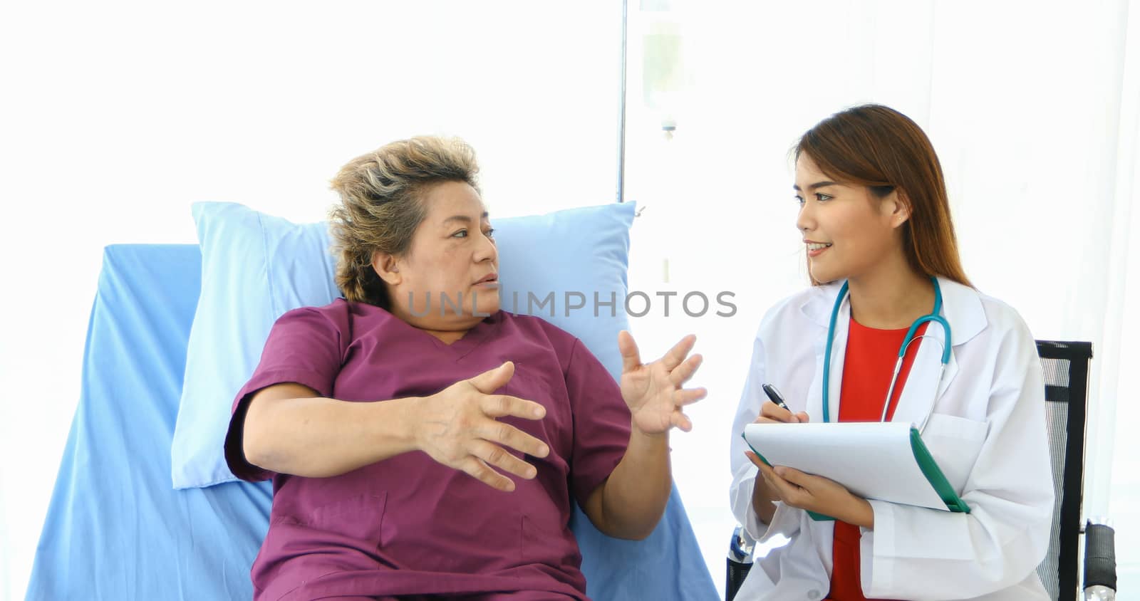 Doctor meeting and explaining medication to old woman patient at Hospitals