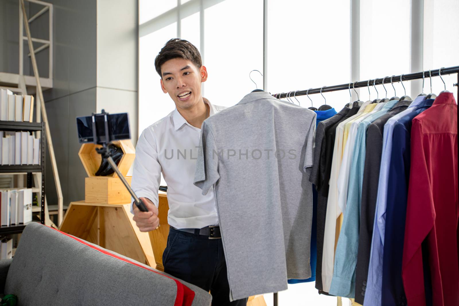 Asian man  blogger broadcasting a video for selling product onli by Tuiphotoengineer