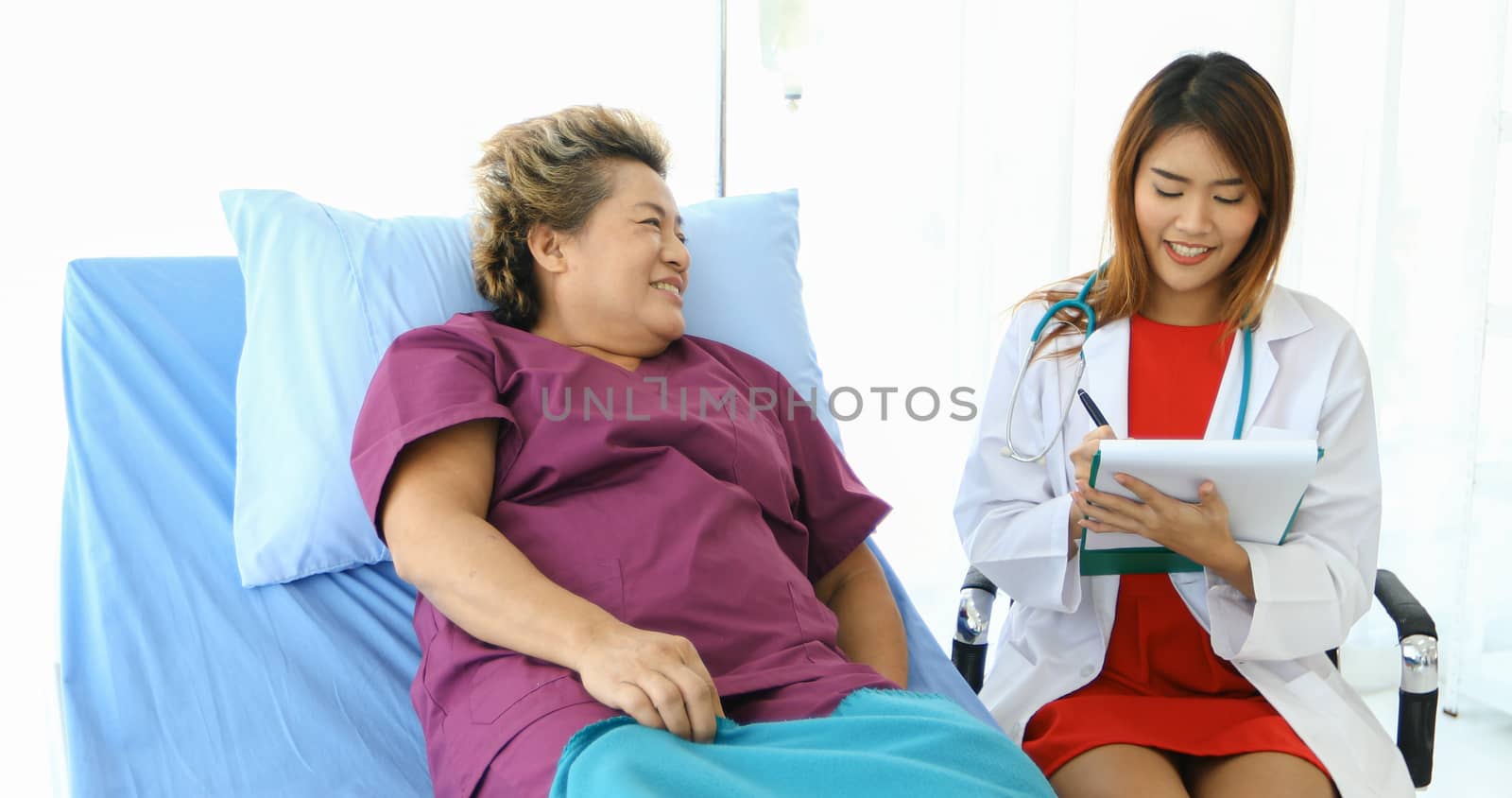 Doctor meeting and explaining medication to old woman patient at Hospitals