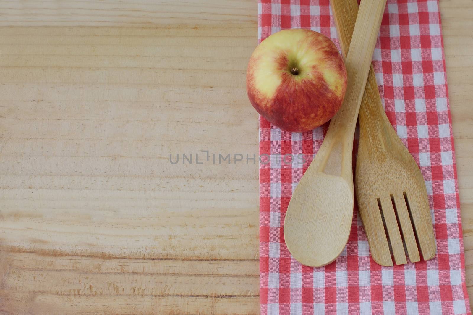 Wooden kitchen utensils on wooden background by Kheat