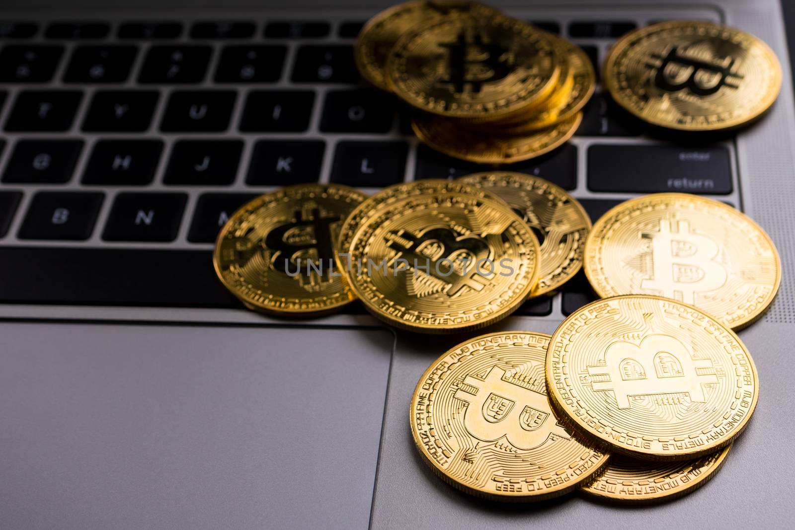Golden coins with bitcoin symbol on computer keyboard. by ronnarong