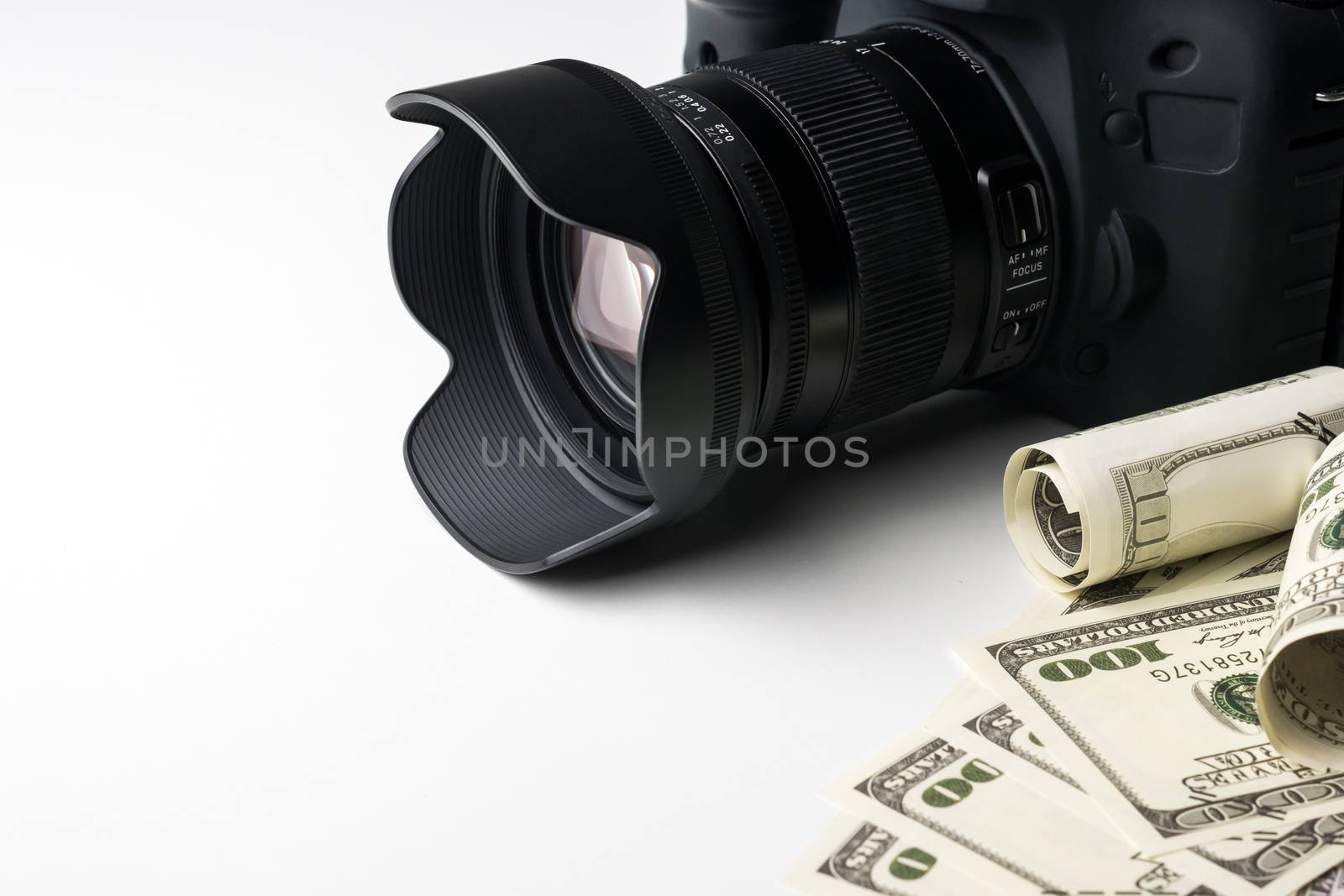 A black digital camera on banknotes with white background. by ronnarong