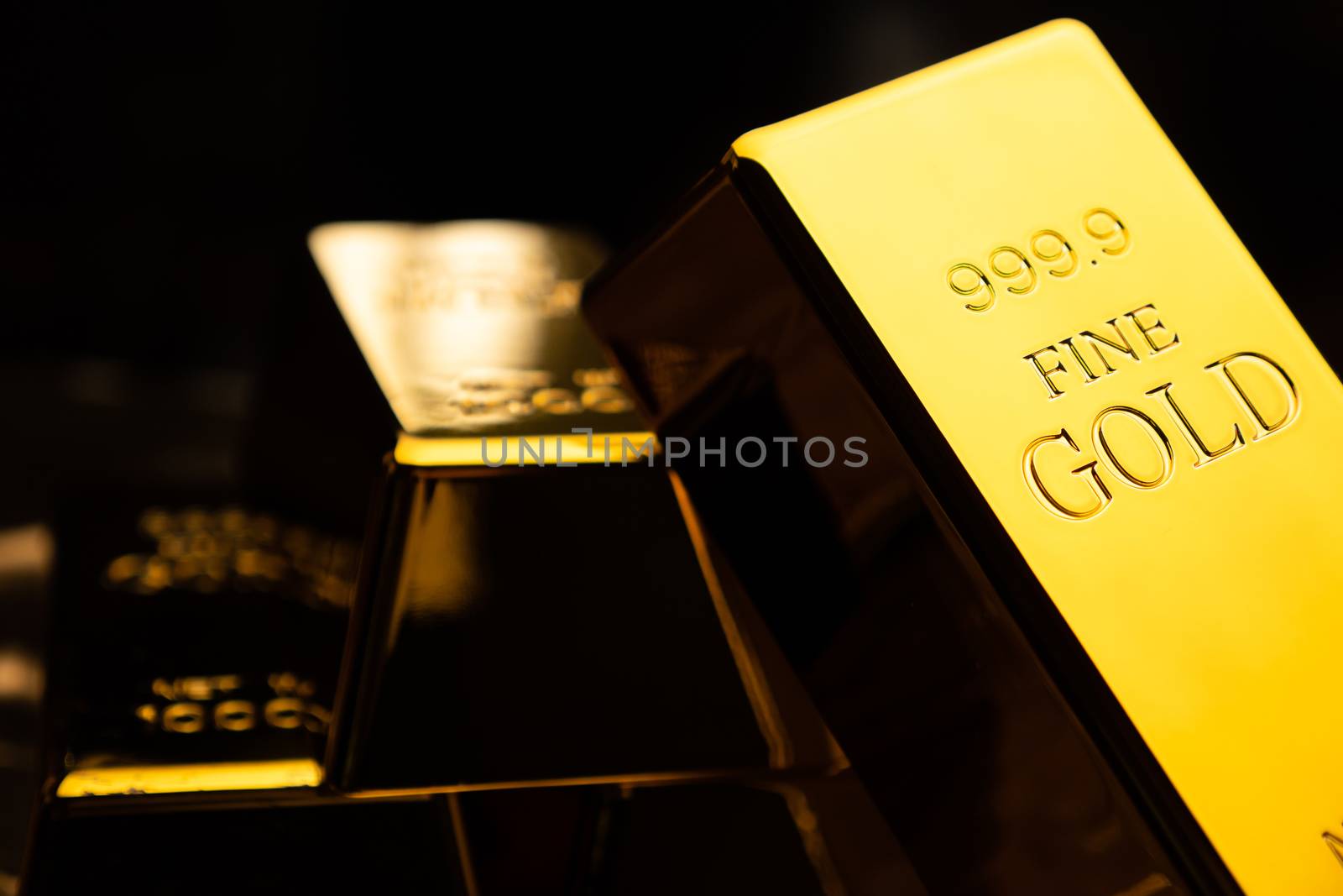 Close up of gold bars on black bacground. financial concept by ronnarong