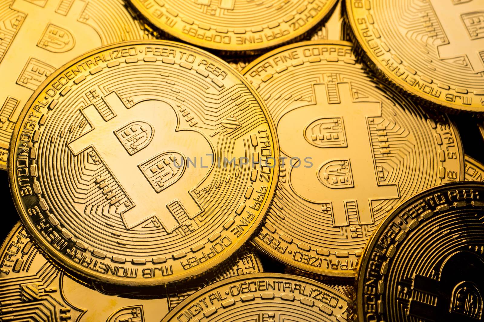 Close up of golden coins with bitcoin symbol background. by ronnarong