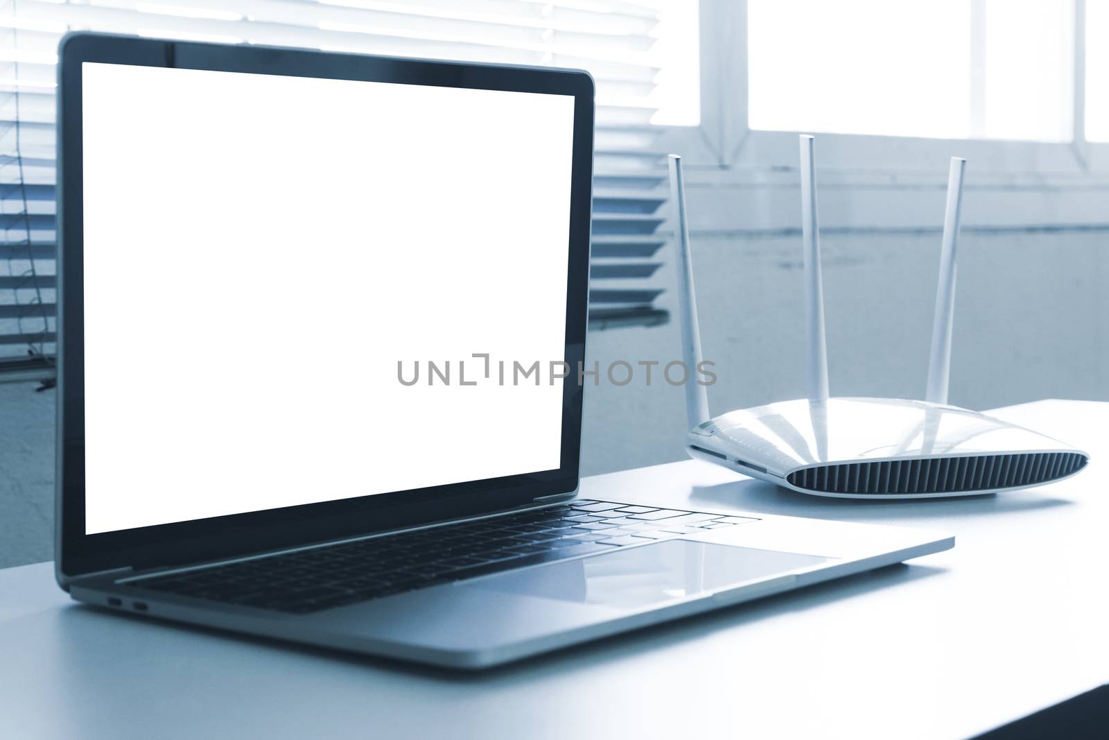 Blank screen laptop computer and router device on the table by ronnarong