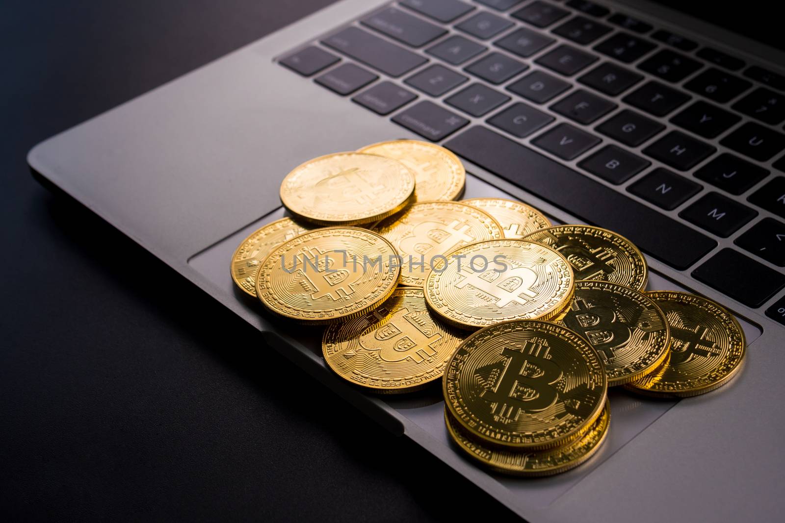 Golden coins with bitcoin symbol on computer.