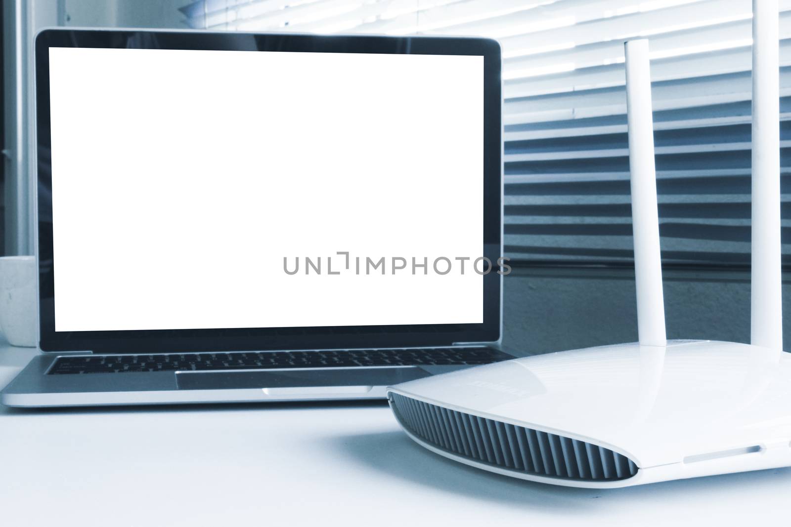 Blank screen laptop computer and router device on the table by ronnarong