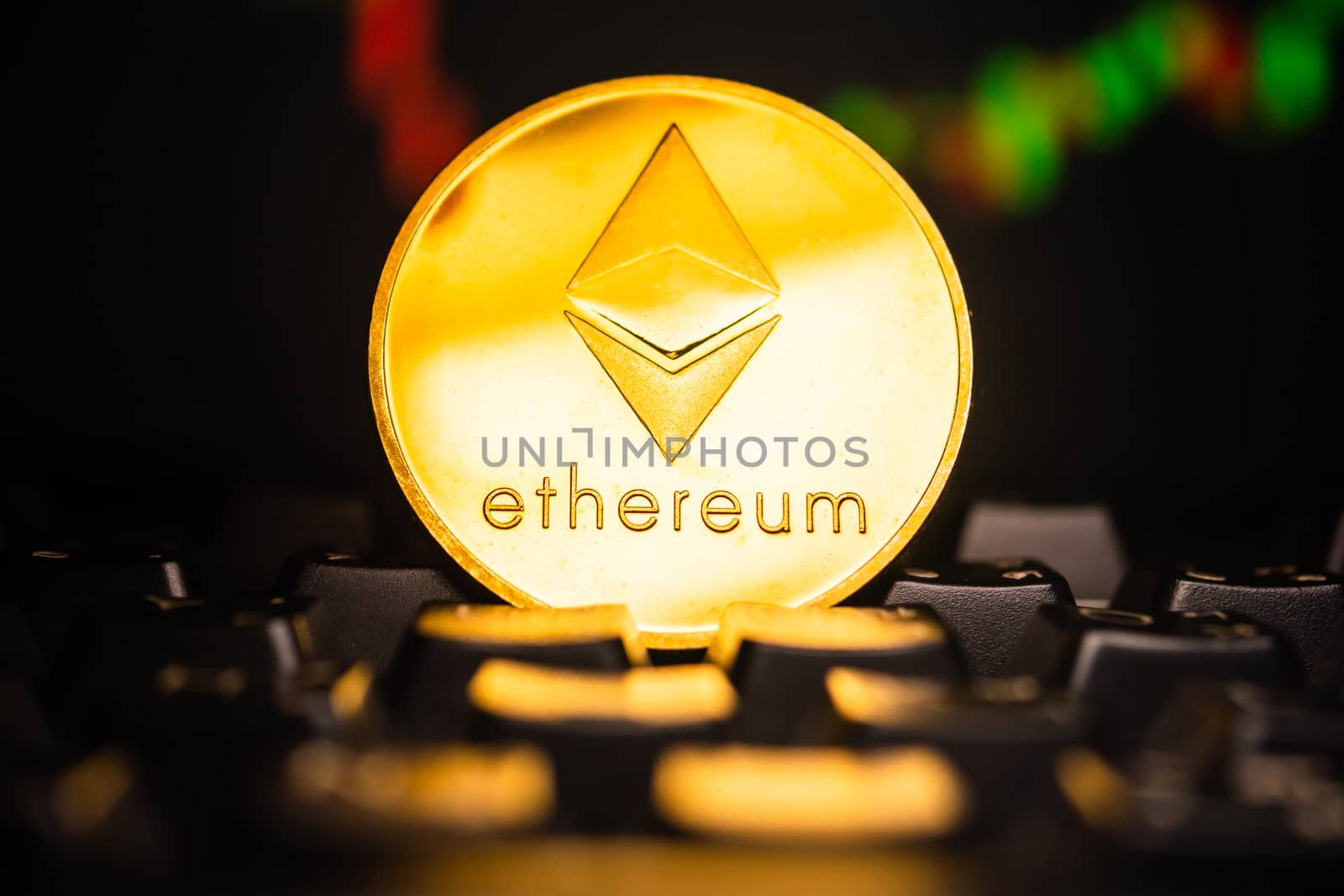 A golden coin with ethereum symbol on computer keyboard with stock graph background.