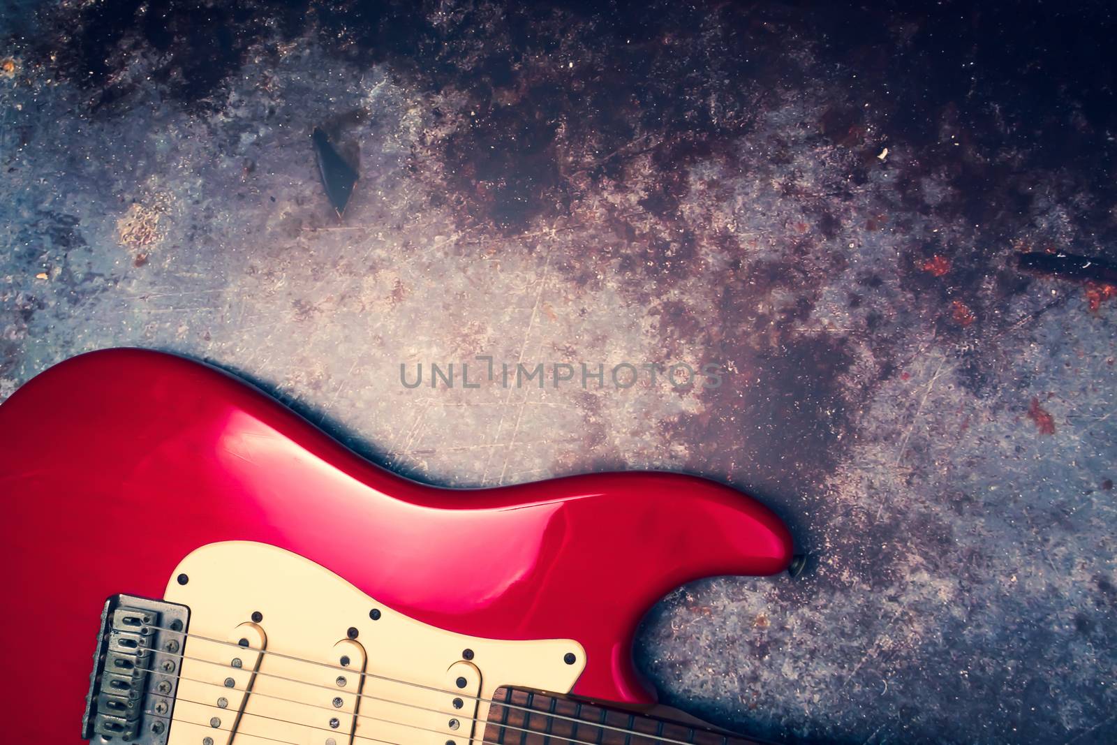 A red electric guitar on a grunge background. by ronnarong