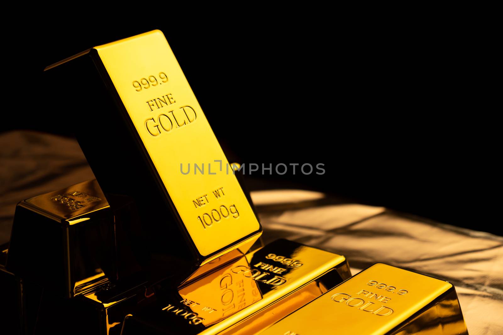 Close up of gold bars on black bacground. financial concept by ronnarong