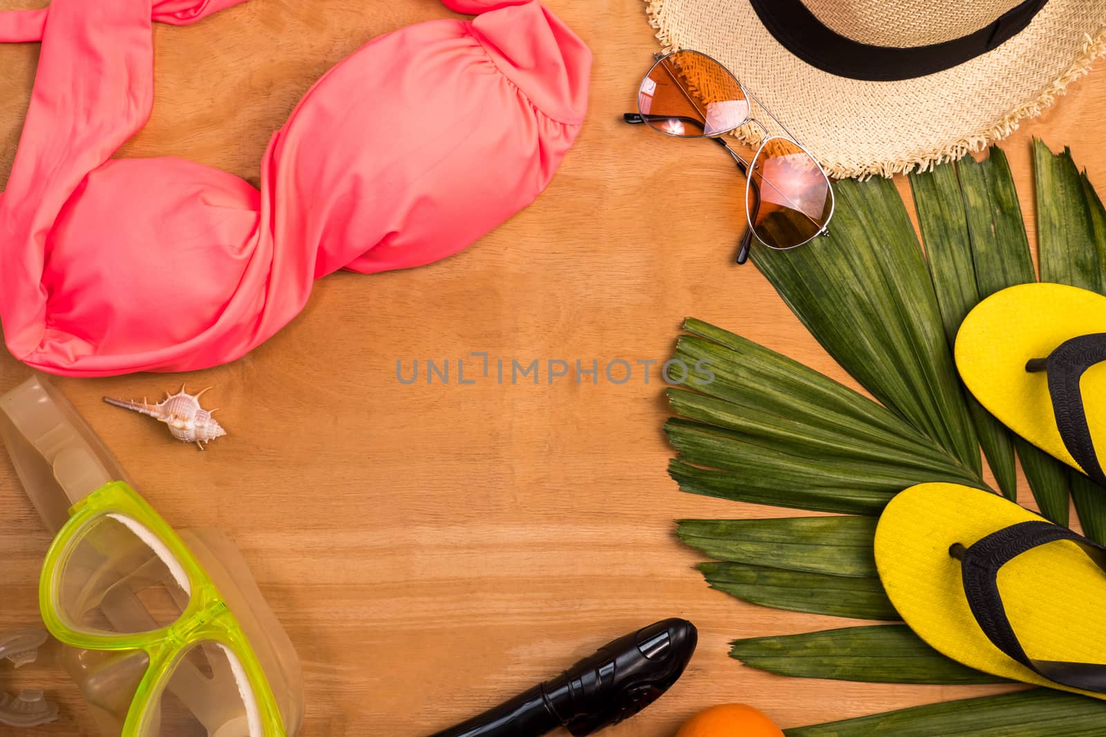 Accerssories for summertime on a wooden background. by ronnarong