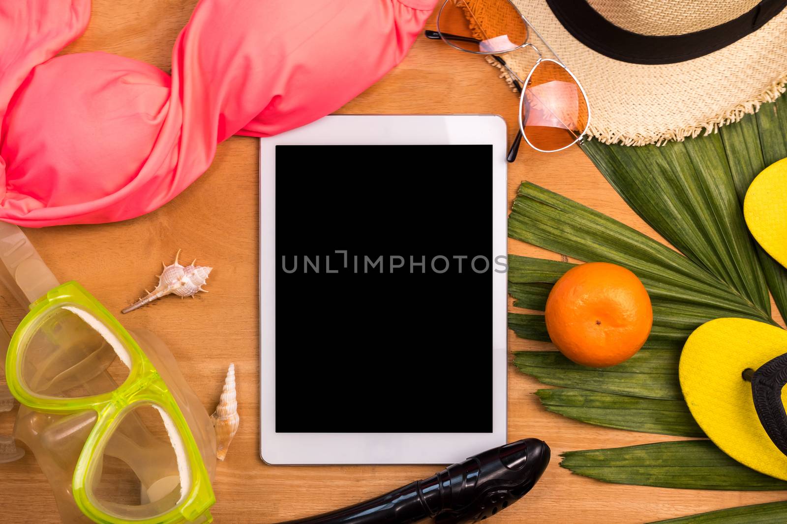 Tablet and Accerssories for summertime on a wooden background. by ronnarong