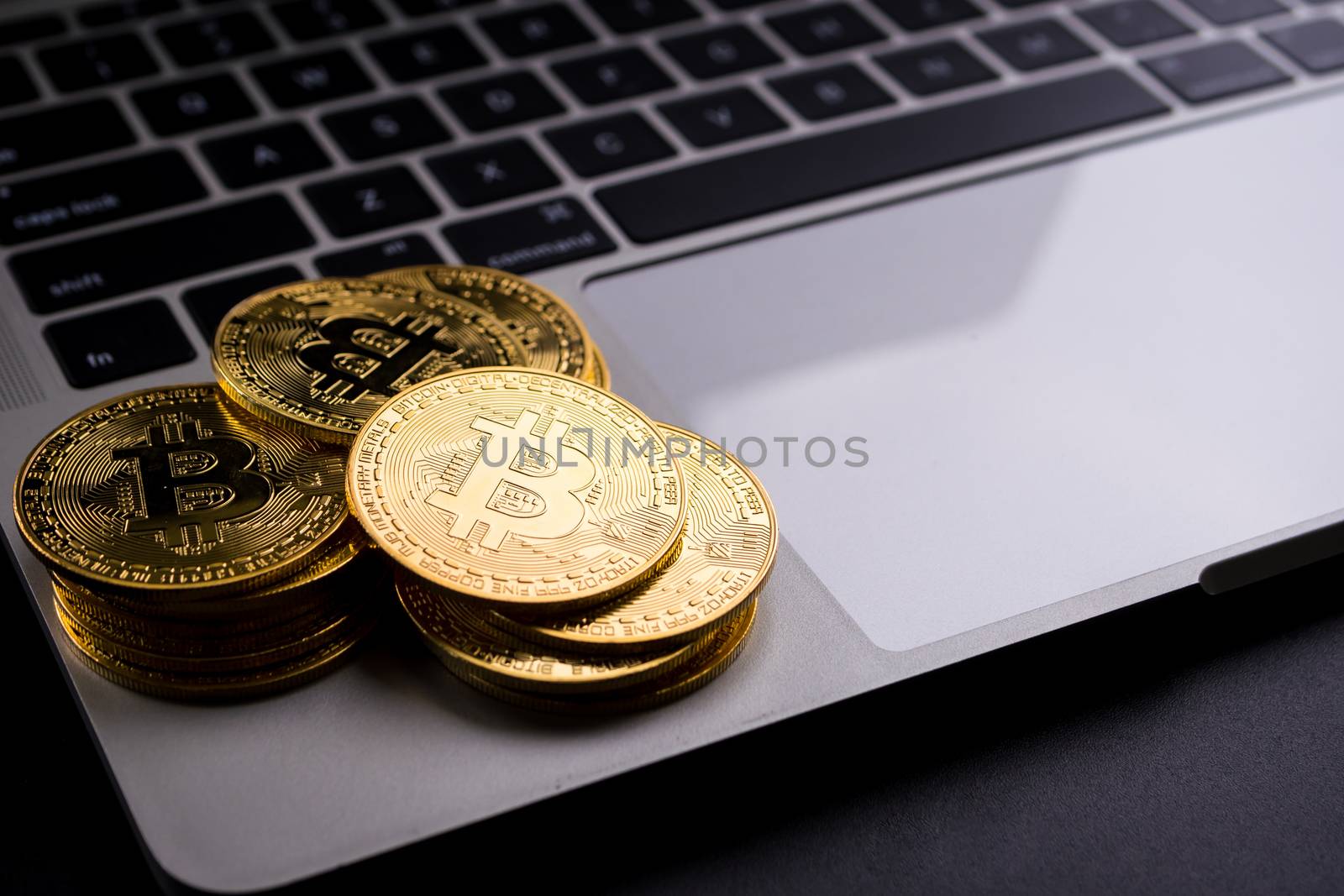 Golden coins with bitcoin symbol on computer.