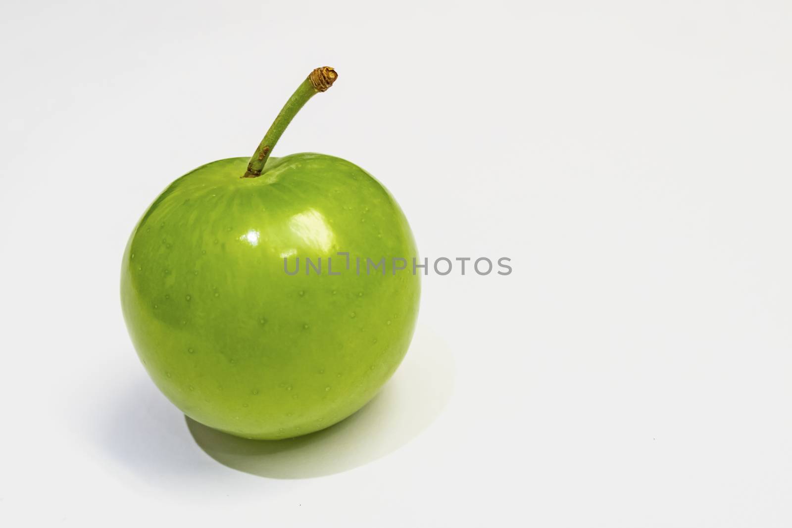 green plum on white background