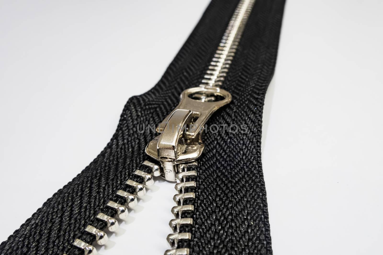 zipper on white background by yilmazsavaskandag