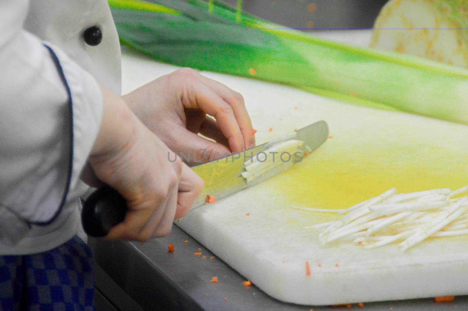 Chef preparing vegetables at a restaurant kitchen