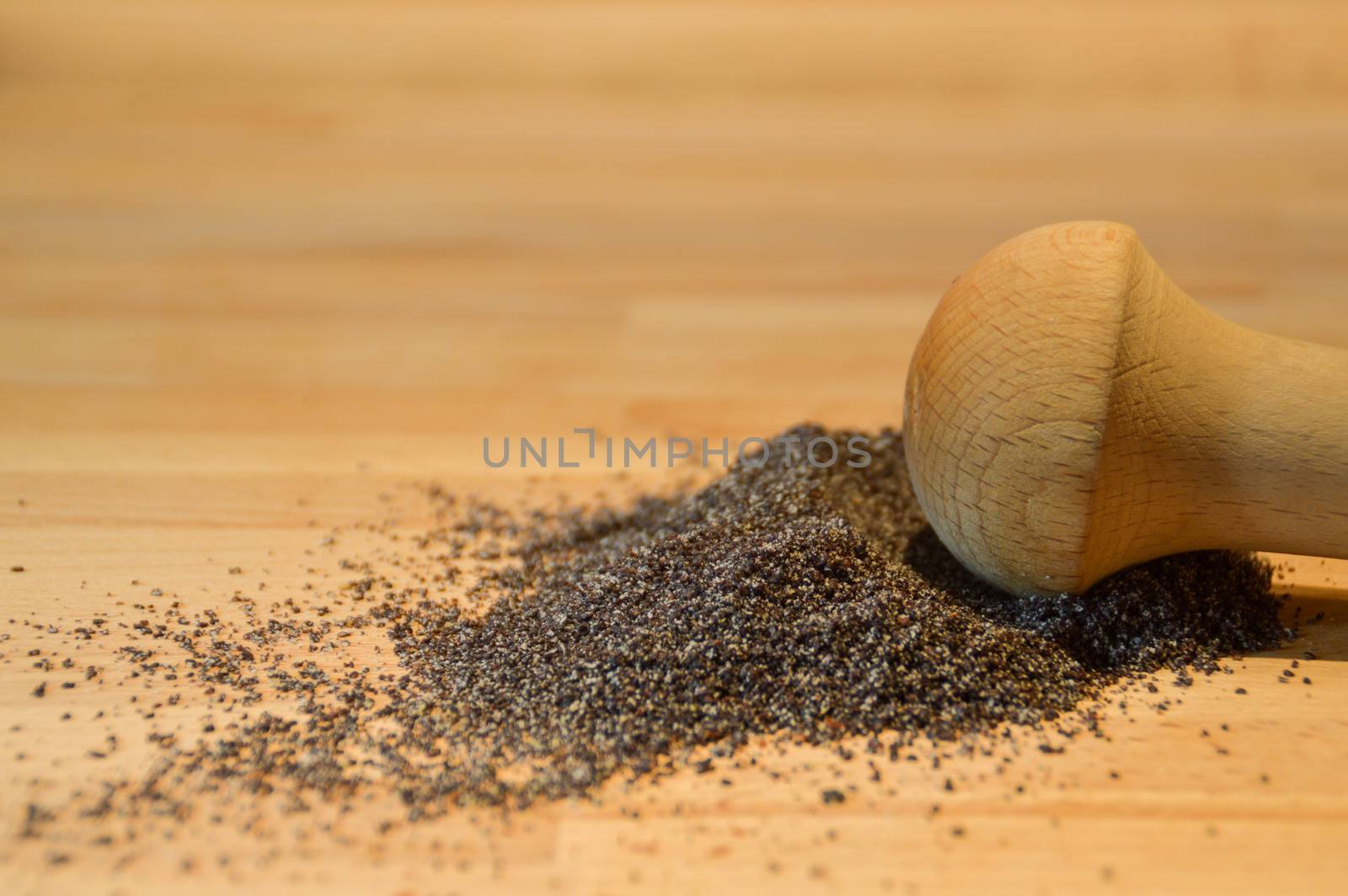 Freshly ground black pepper against a wooden table