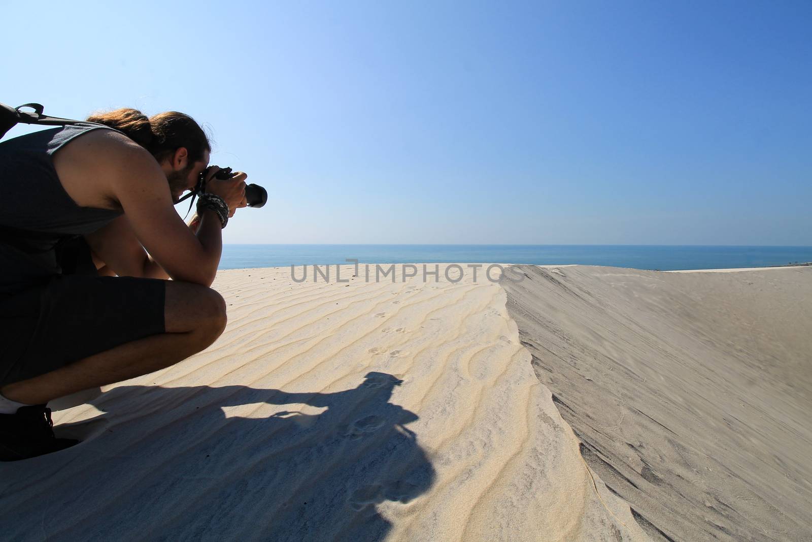 A man taking photos of the desert in Phan ri cua, Vietnam