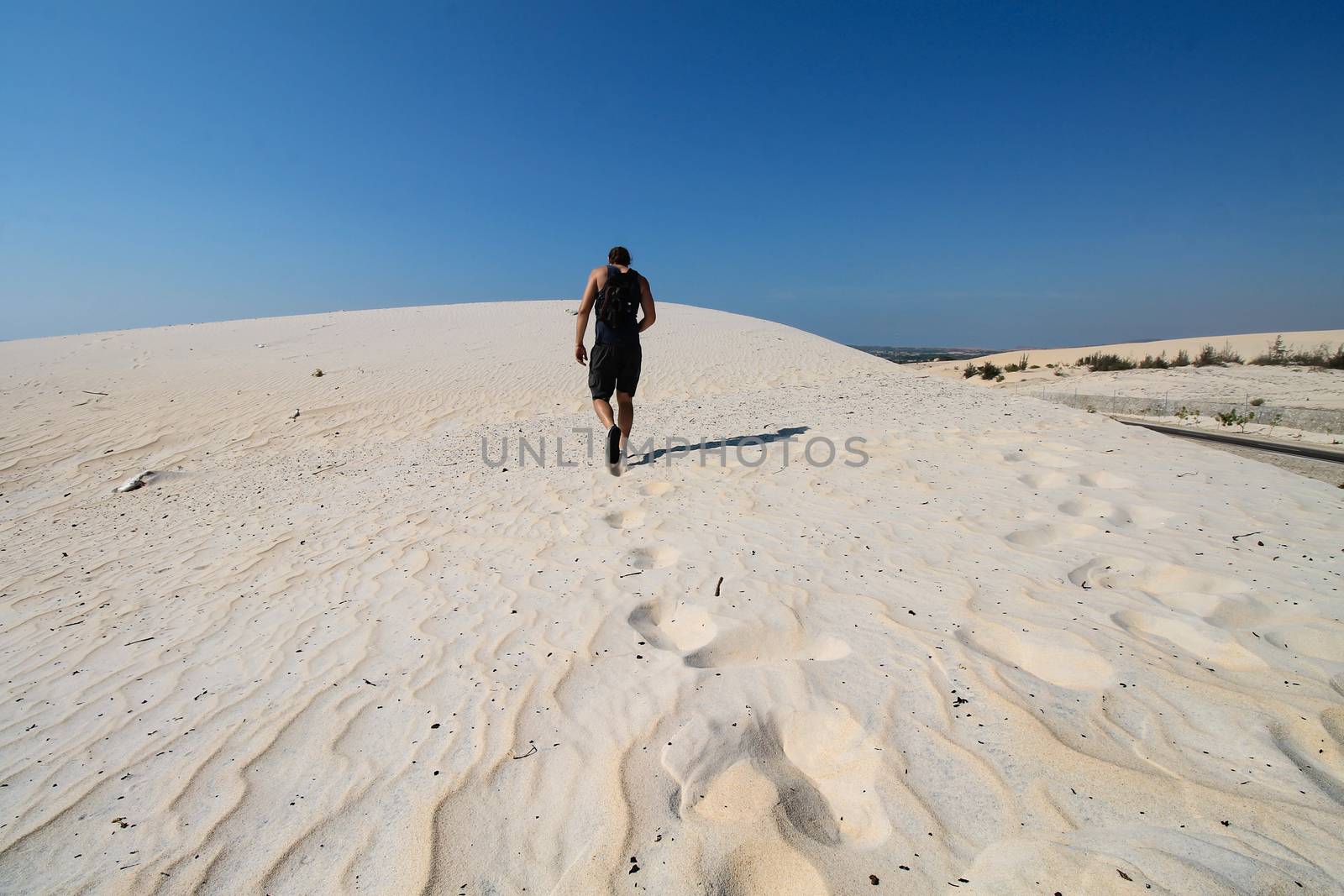 Solo traveler walking in the desert of Phan ri cua, Vietnam