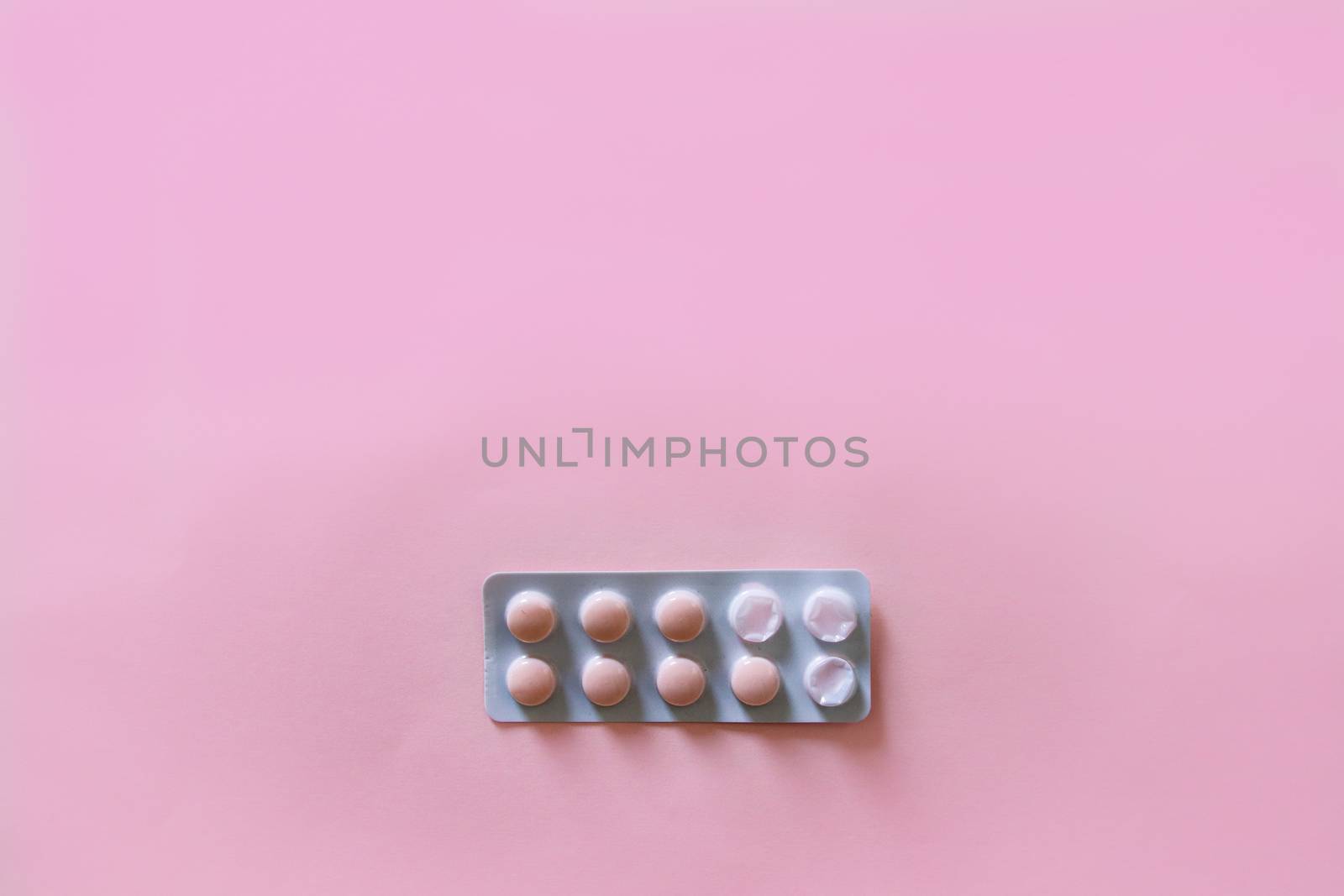 Packet of Pills Against Pink Background