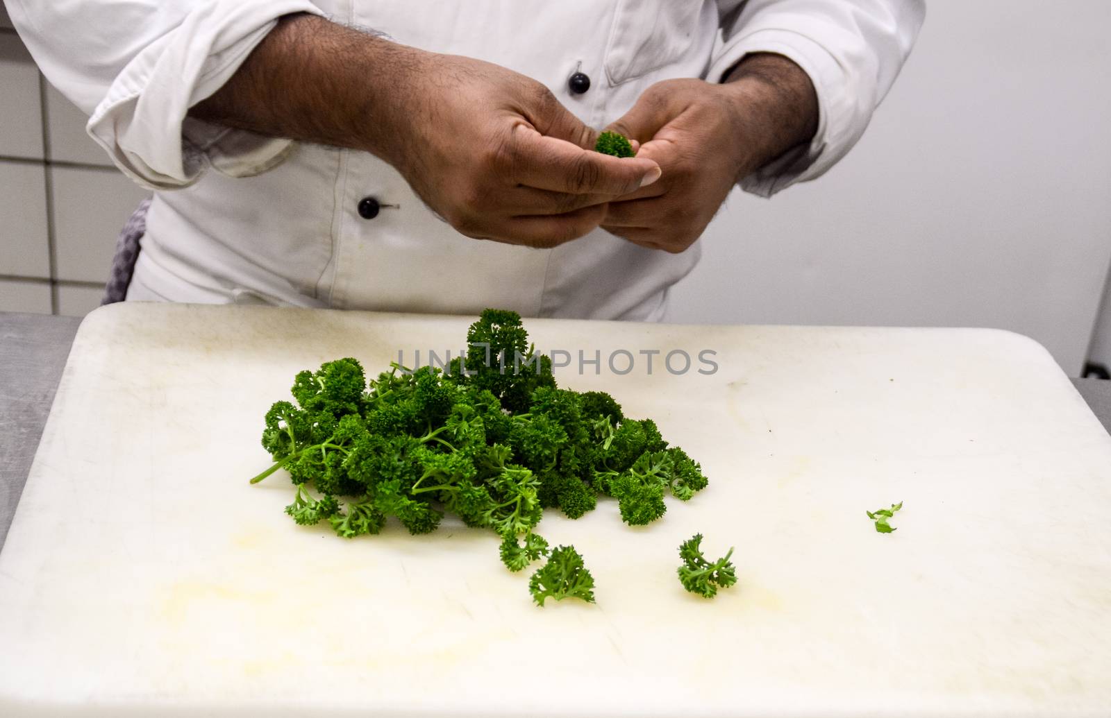 A chef preparing food in the restaurant kitchen amidst the threat of the covid-19 pandemic