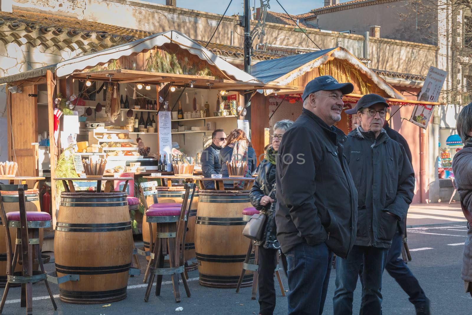 Marseillan, France - December 30, 2018: Street atmosphere in the Christmas market of the city where people walk on a winter day