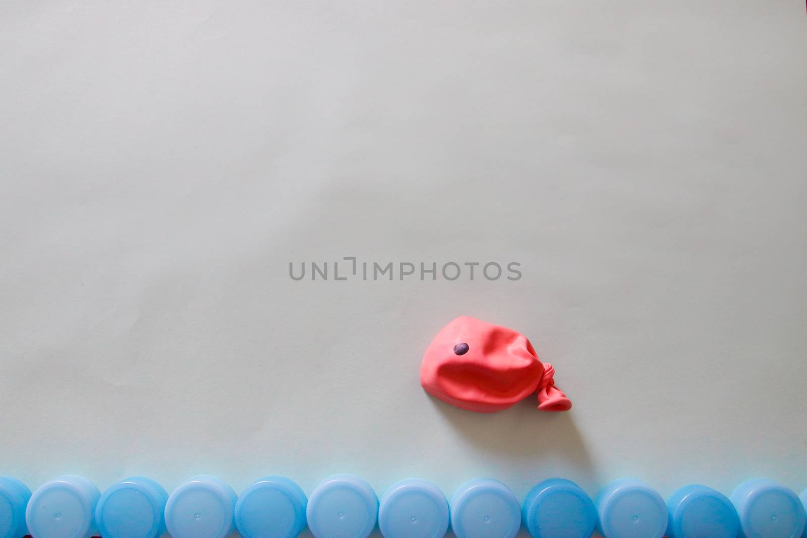 Conceptual photo of a balloon shaped like a fish to show concept of ocean pollution and environmental damage