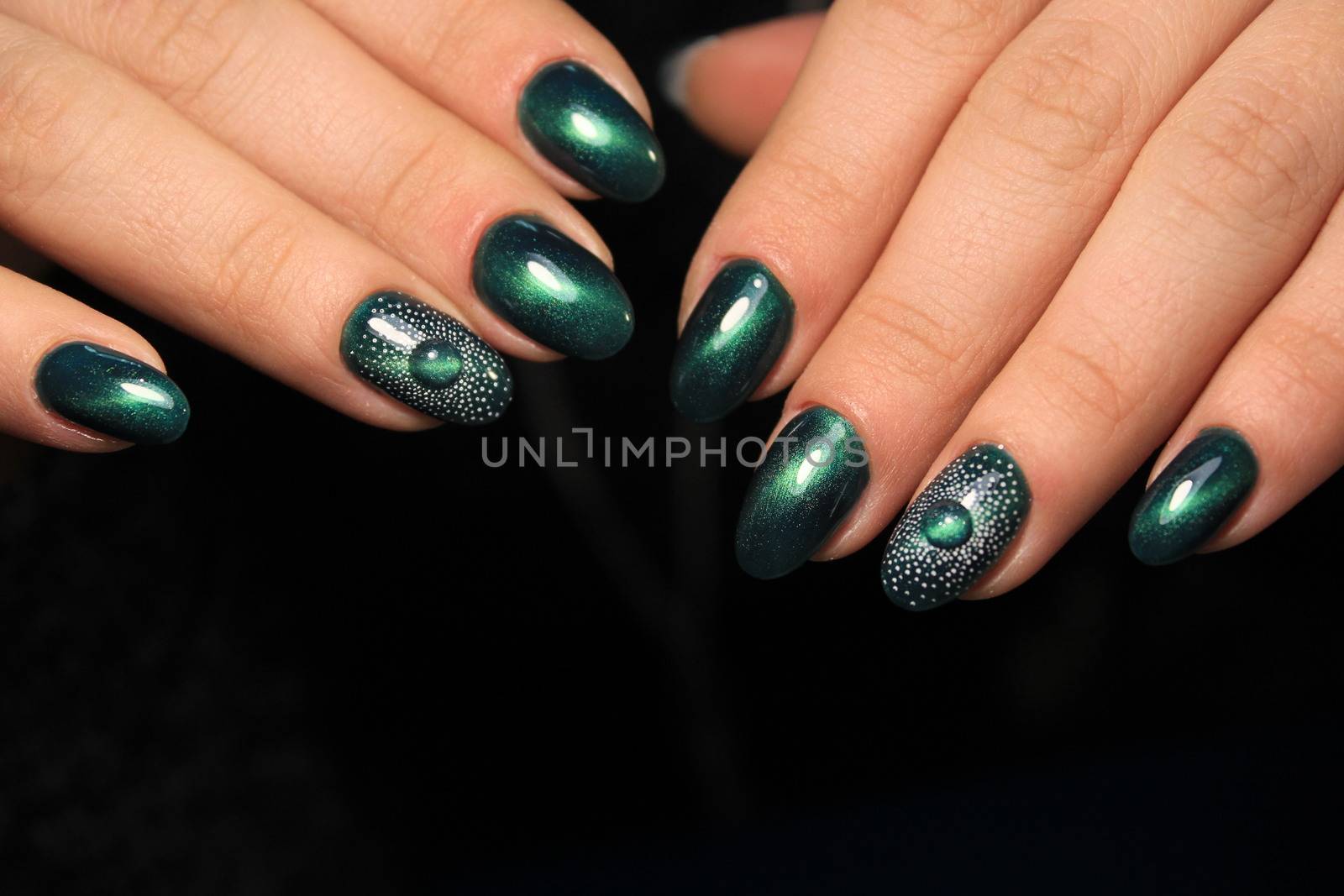 Closeup photo of a beautiful female hands with elegant manicure and diamond rings.