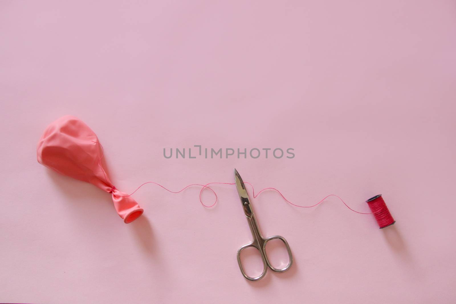 Plastic Balloon and Scissors showing concept of Plastic Use Reduction