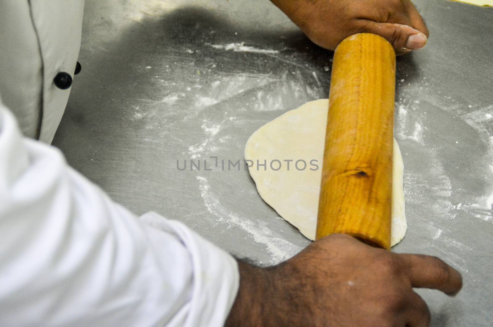 A chef kneading dough with a rolling pin by Sonnet15