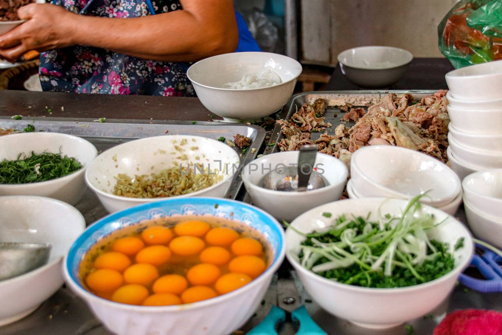 Street food stall selling traditional Vietnamese noodles or pho in the streets of Hanoi City which shows the food culture and tradition of Vietnam