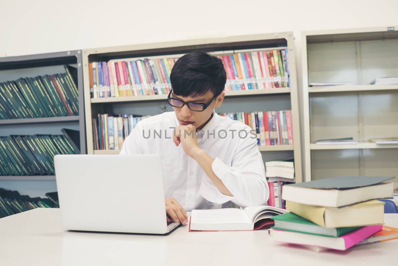 Student making research on laptop and browse internet. Education by Johnstocker