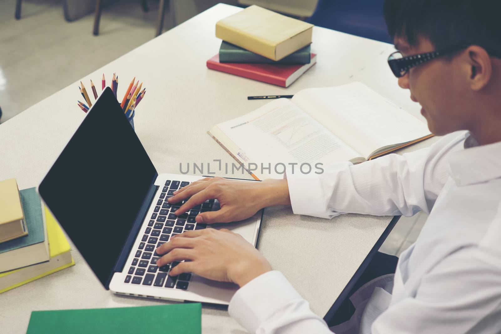 Student making research on laptop and browse internet. Education by Johnstocker