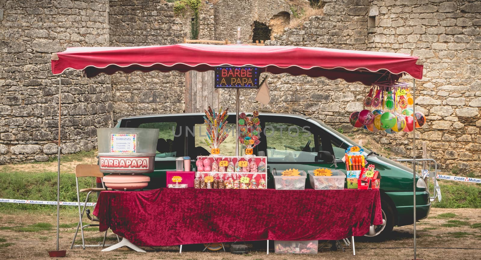 Commequiers, France - September 04, 2016: Cotton candy and marshmallow stand in front of Commequiers castle on a summer day