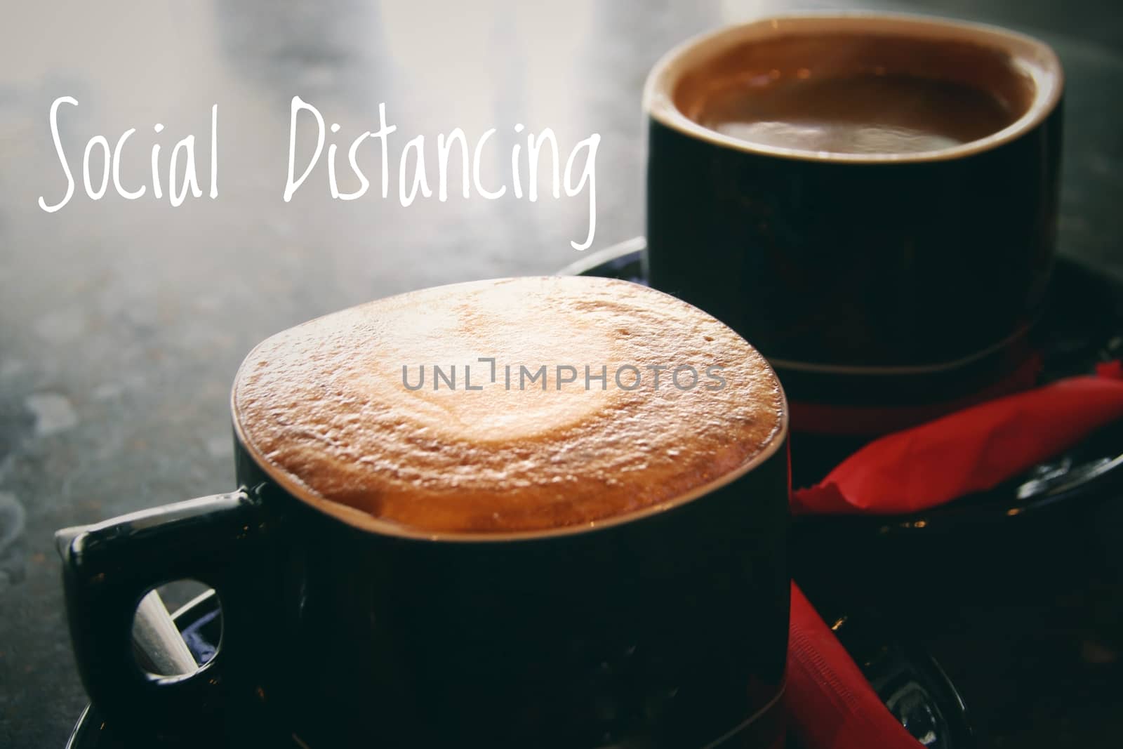 Conceptual still life showing two cups of coffee to show concept of social distancing