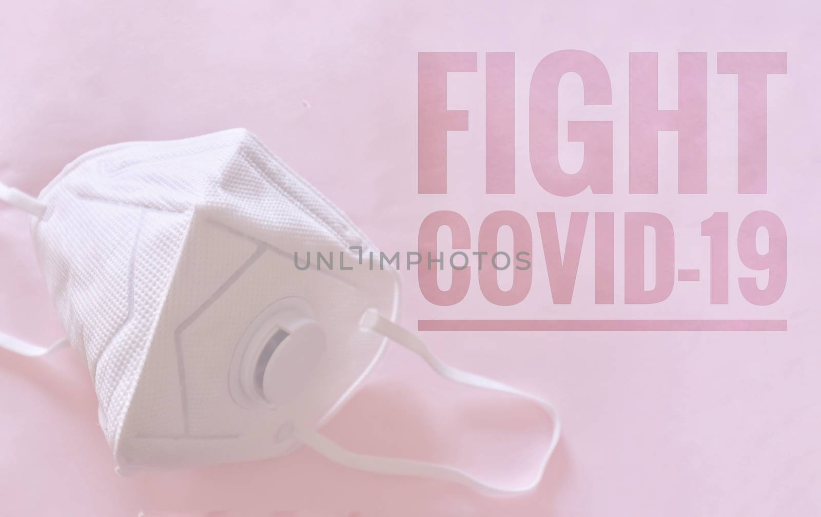 N95 mask against a pink background with the words Fight Covid-19 written on it to raise awareness in fighting the coronavirus global pandemic crisis