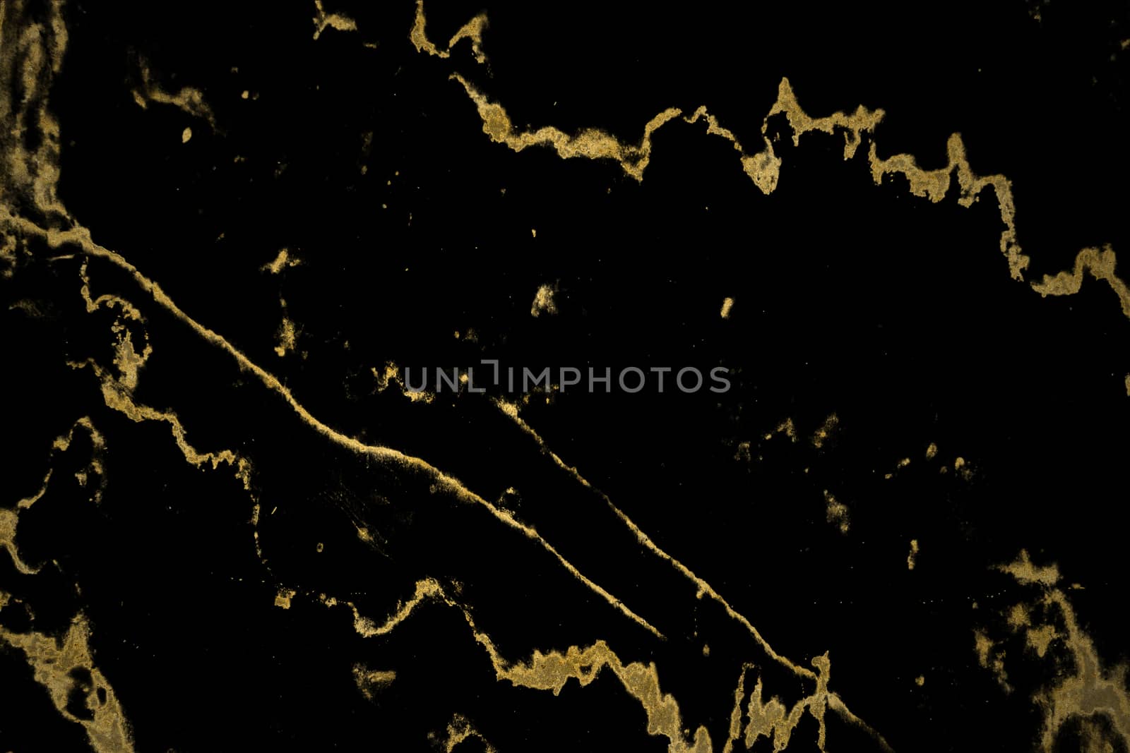mineral gold in black marble surface of cave for interior wallpaper and background