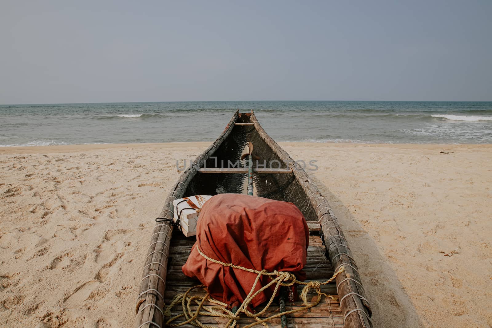 Traditional Vietnamese wooden boat moored at the beach of Hue, Vietnam