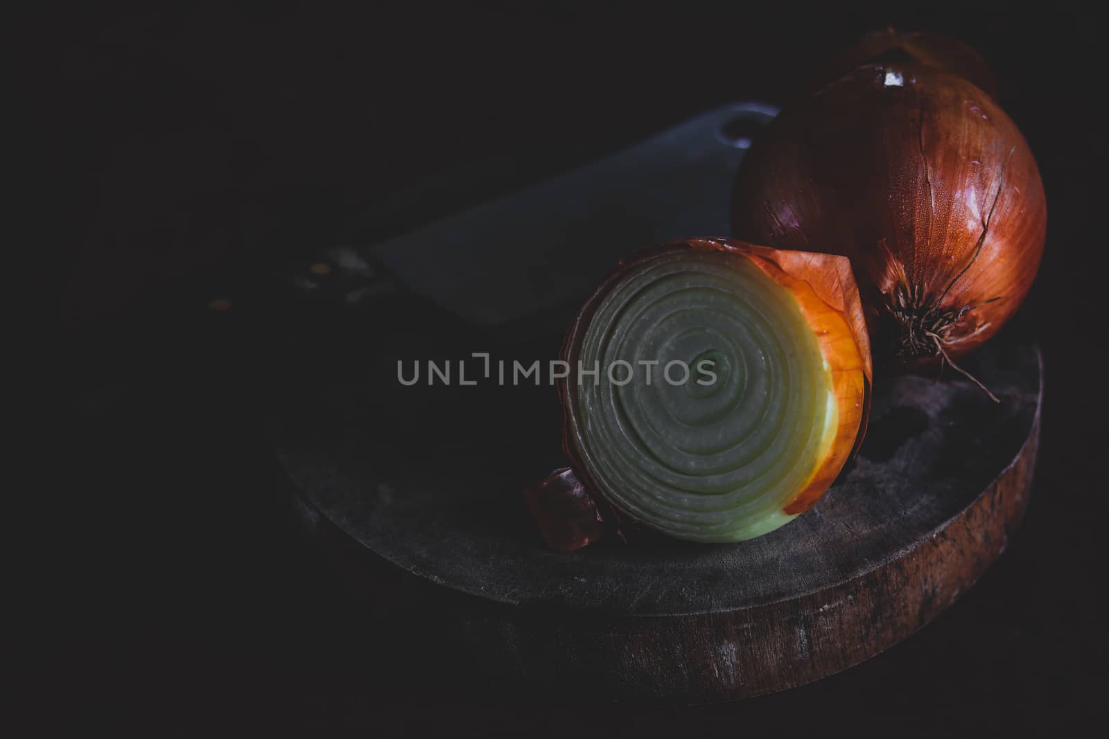 Bulbs of Onions shot in low light dark and moody theme to show concept of gastronomy, clean living and healthy diet