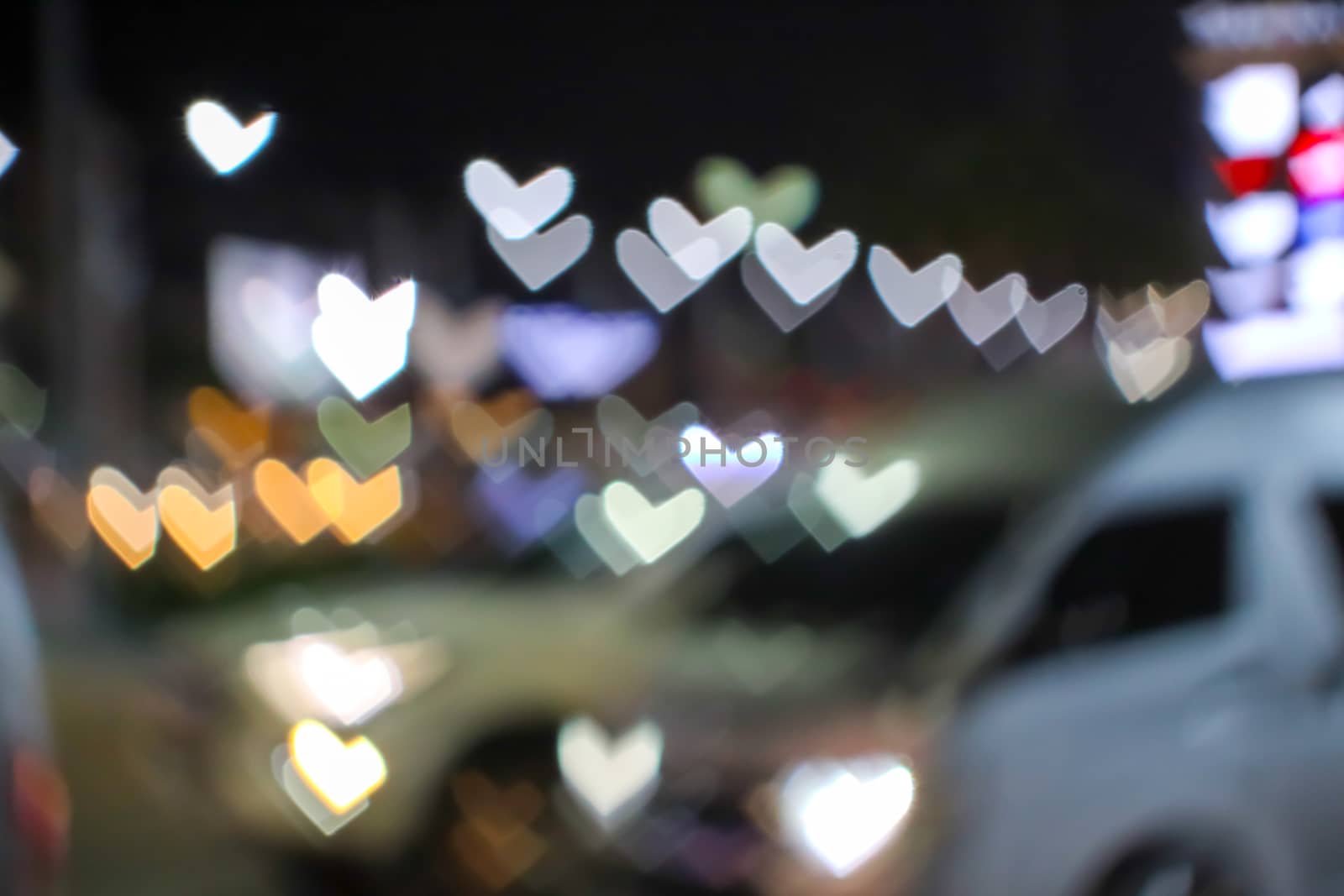 blur and bokeh heart shape love valentine colorful night light on the road