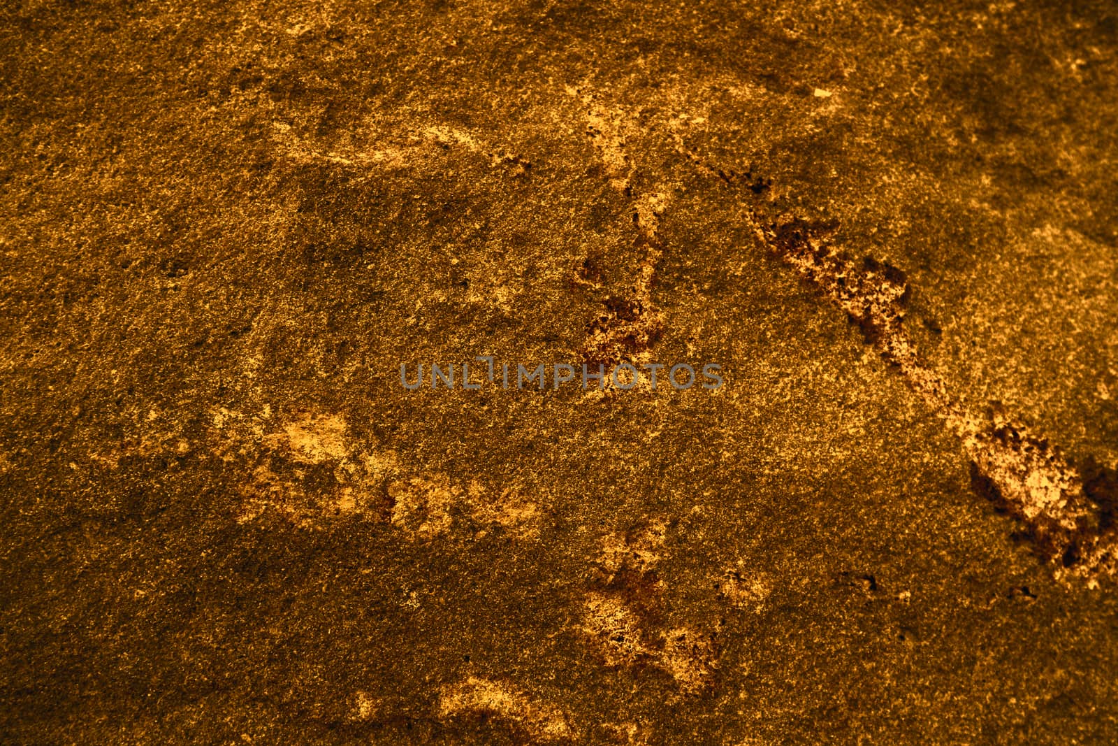 ancient dark orange granite stone surface of cave for interior wallpaper and background