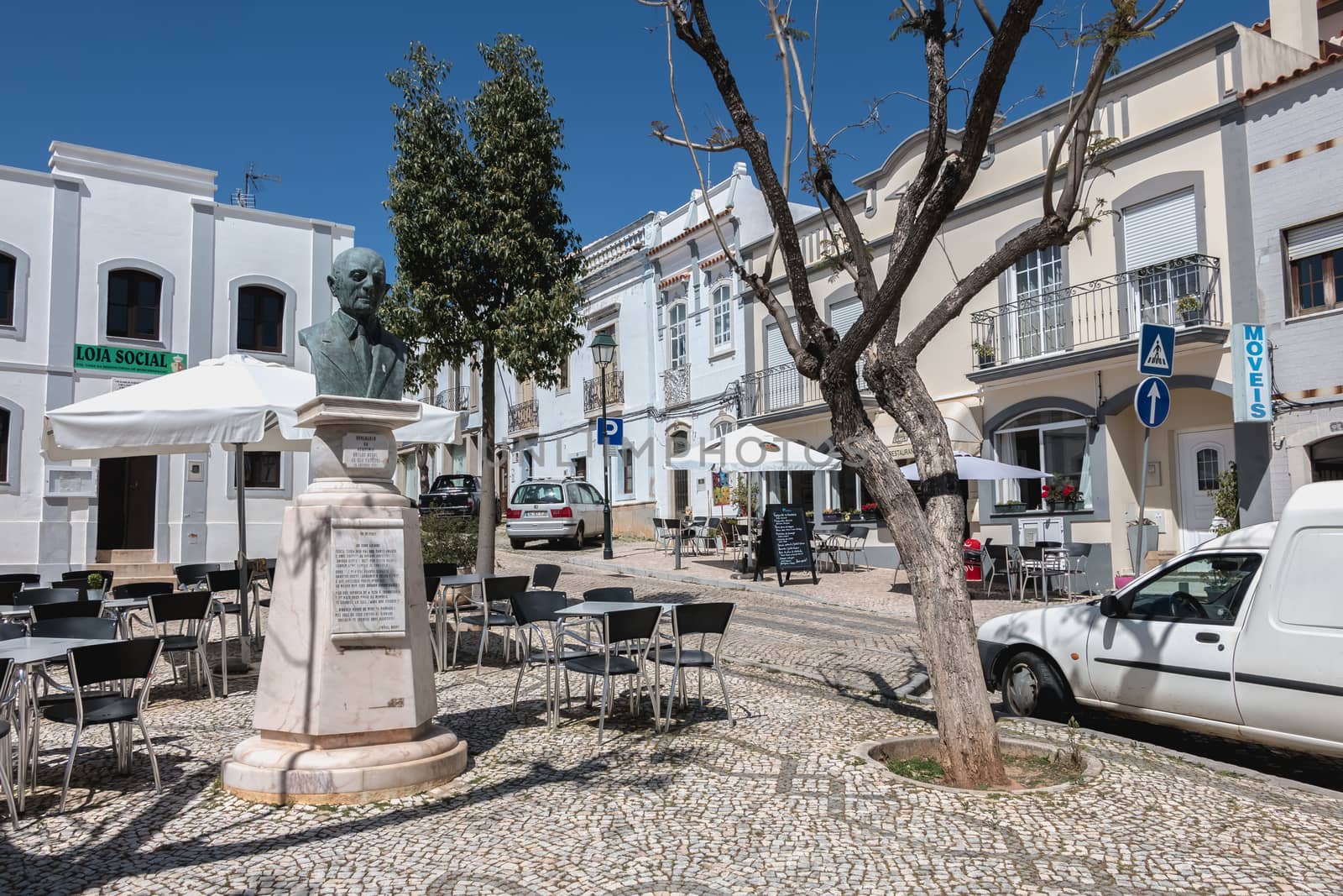 Moncarapacho, Portugal - May 4, 2018: Street atmosphere and architecture typical of a small town in the Algarve where people are walking on a spring day