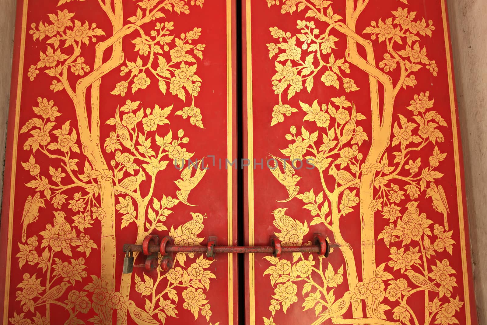 Traditional Chinese motifs on Chinese wooden doors in the Emerald Buddha housed, wat Phra Kaew Temple Bangkok, Thailand