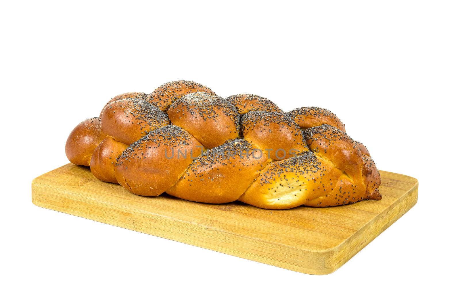 Fresh whole challah bread on chopping board isolated on white background with clipping path