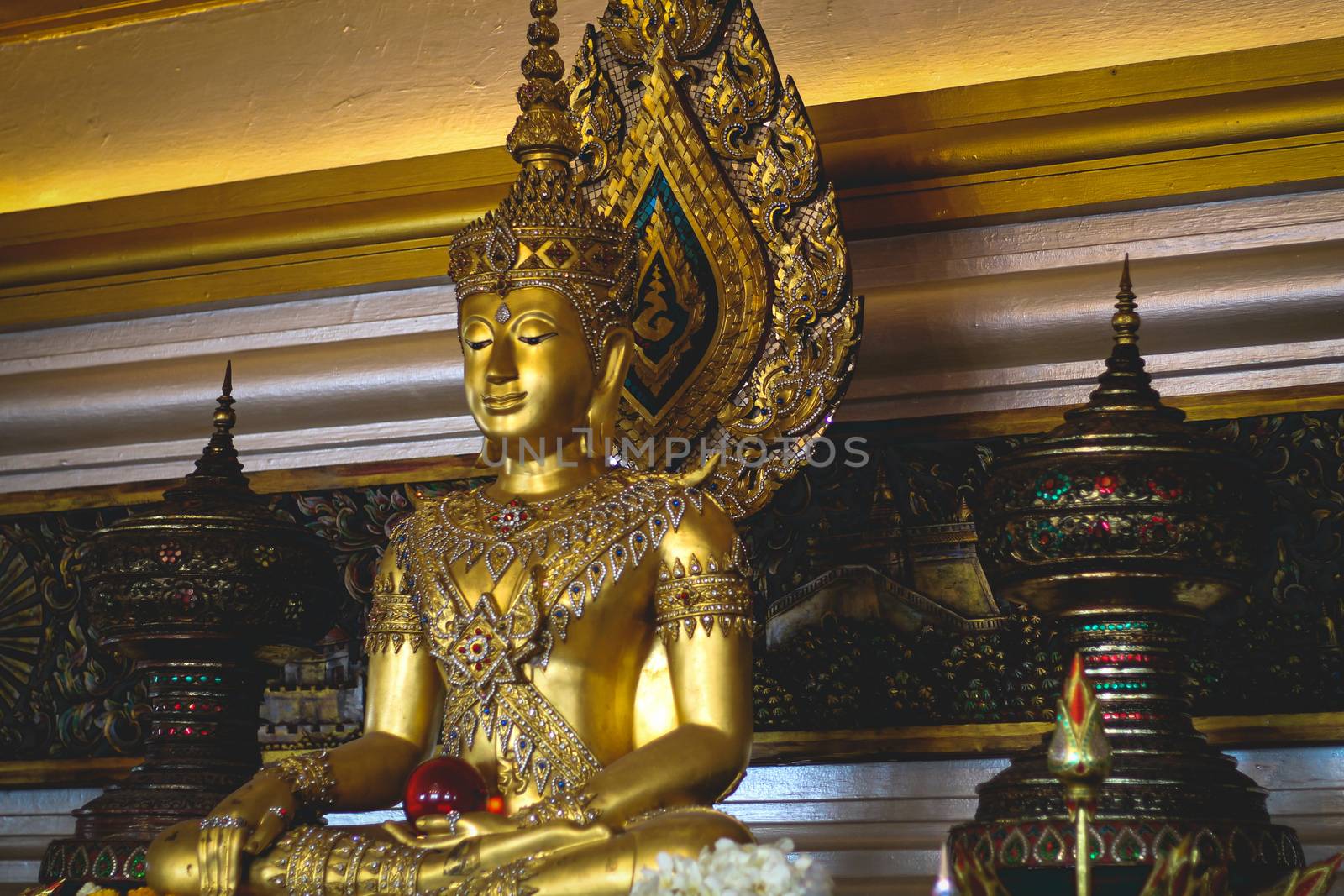 Golden Mahayana Buddhist statue in a public altar in the street of Yaowarat or Chinatown in Bangkok, Thailand